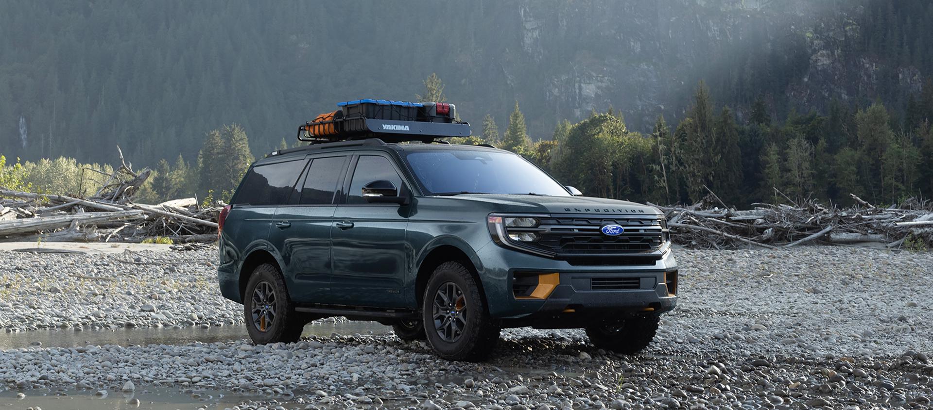 2027 Ford Expedition® Tremor® SUV with optional equipment and available Ford accessories shown parked on gravel
