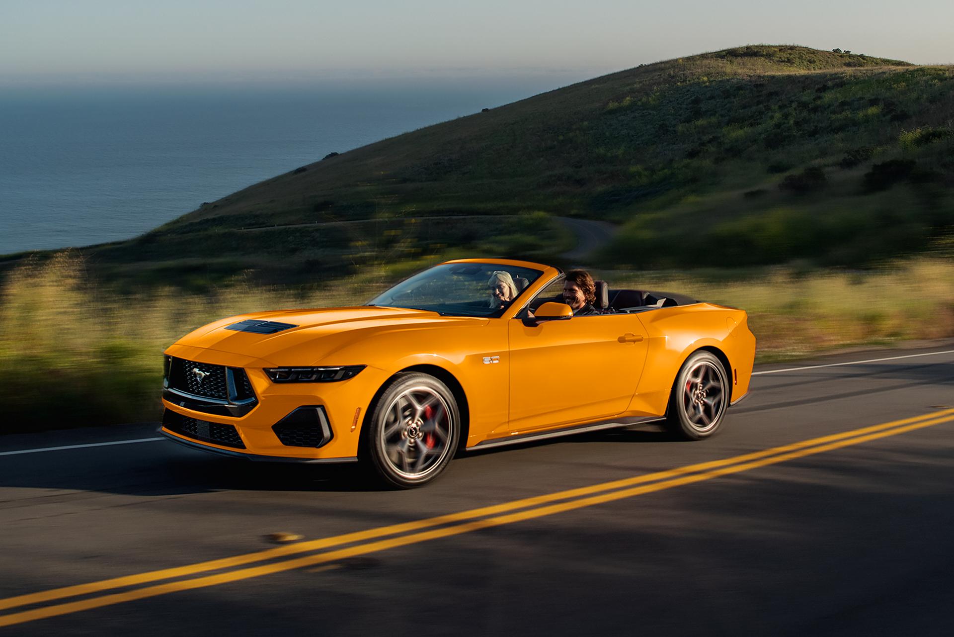 Two people driving in a 2026 Ford Mustang® GT convertible