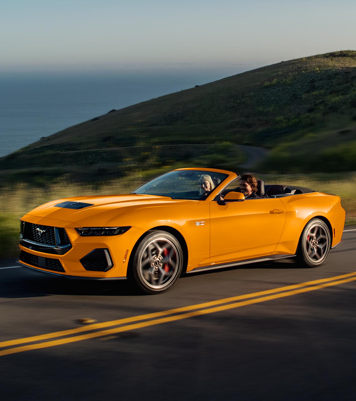 Two people driving in a 2026 Ford Mustang® GT convertible