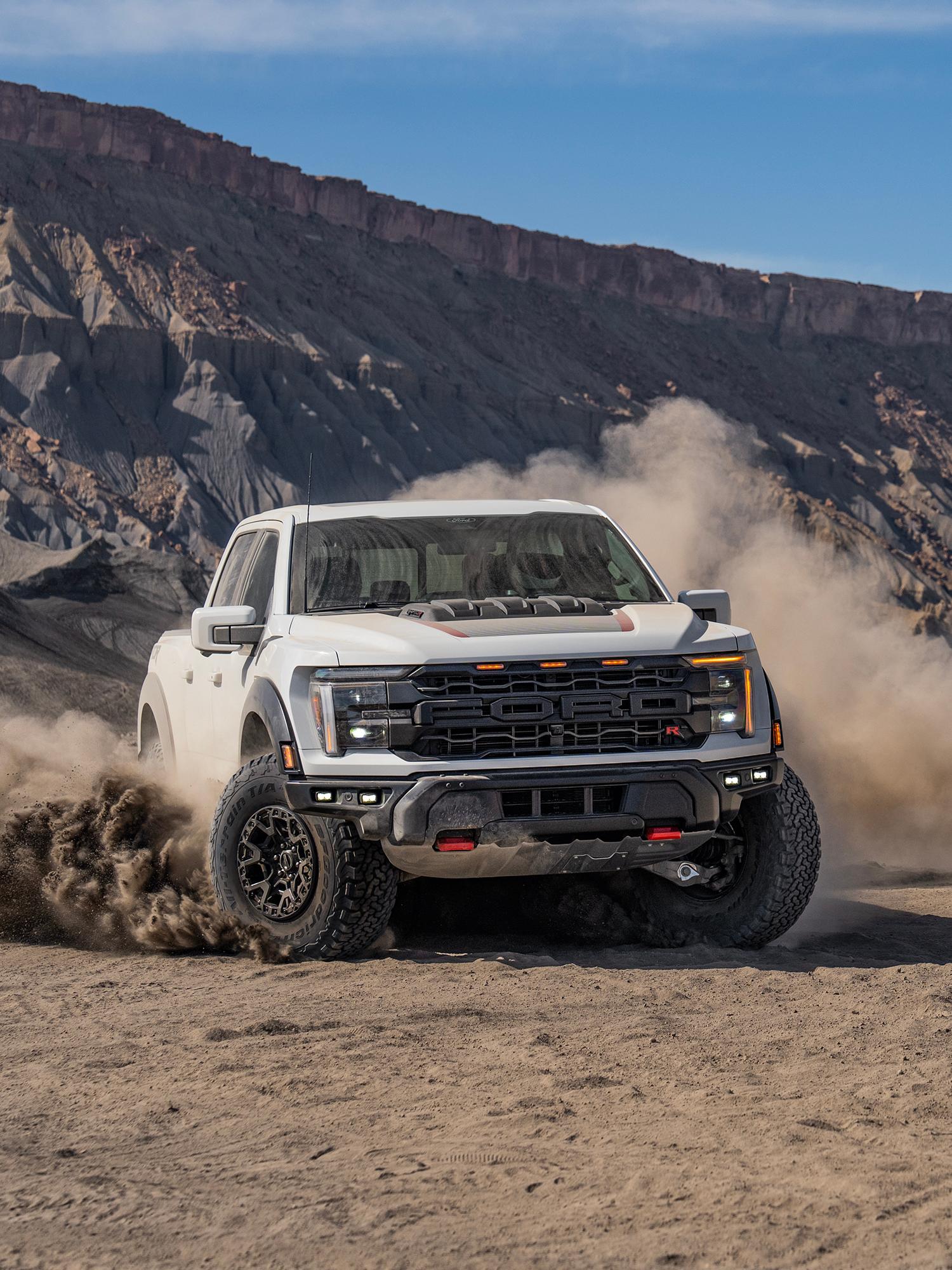 A 2024 Ford F-150® truck on a dirt road with clouds of dust around it