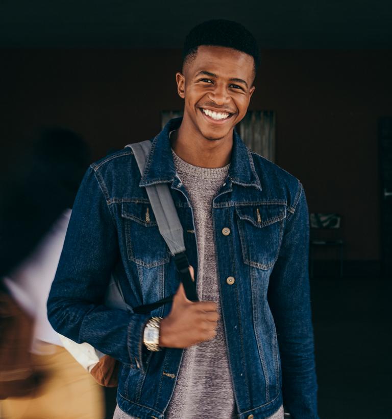 A young man wearing a backpack