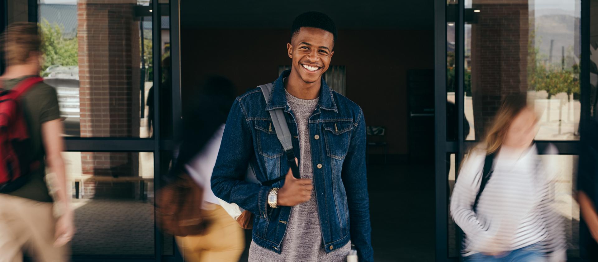 A young man wearing a backpack