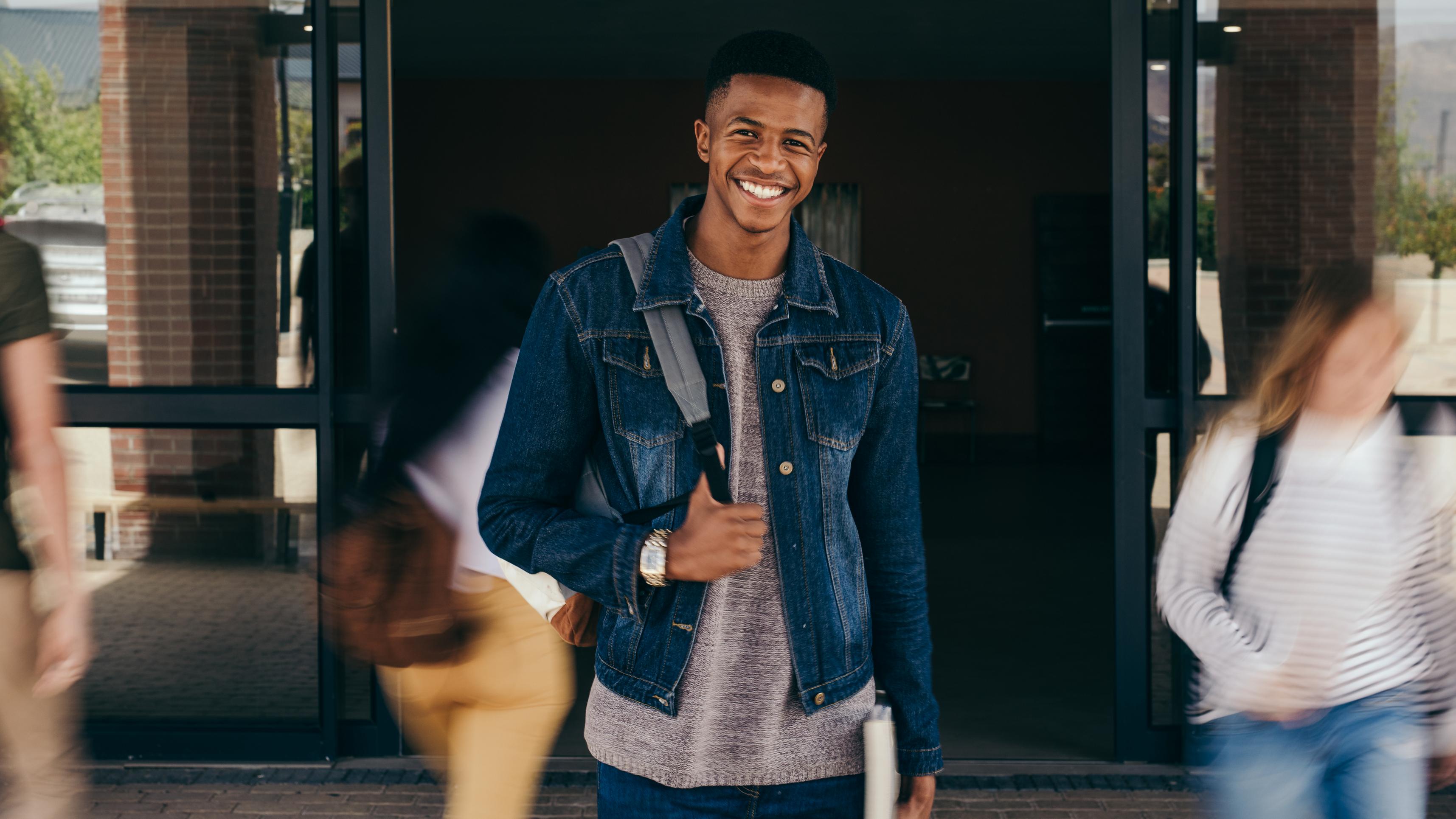 A young man wearing a backpack