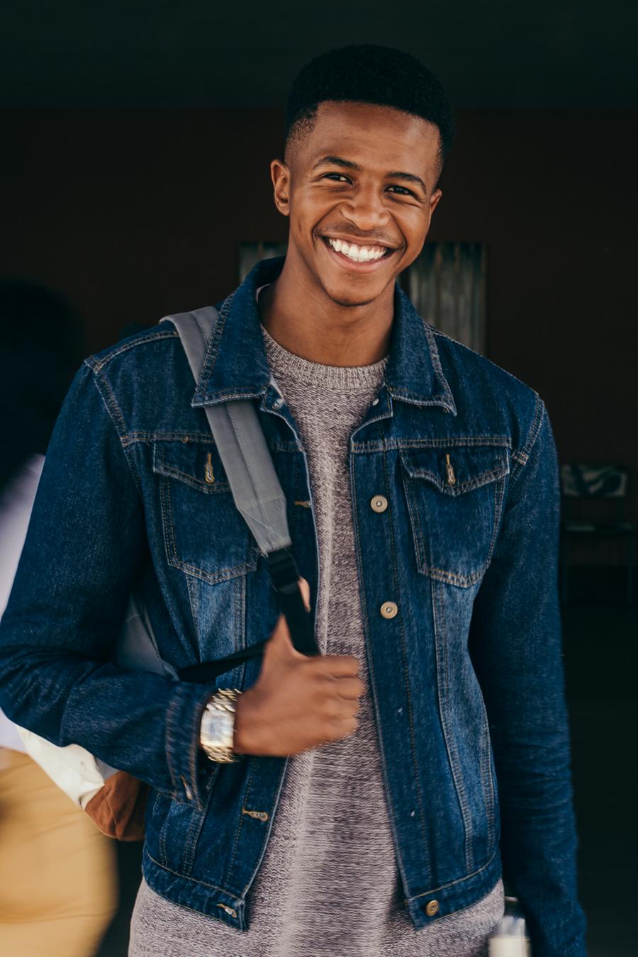 A young man wearing a backpack