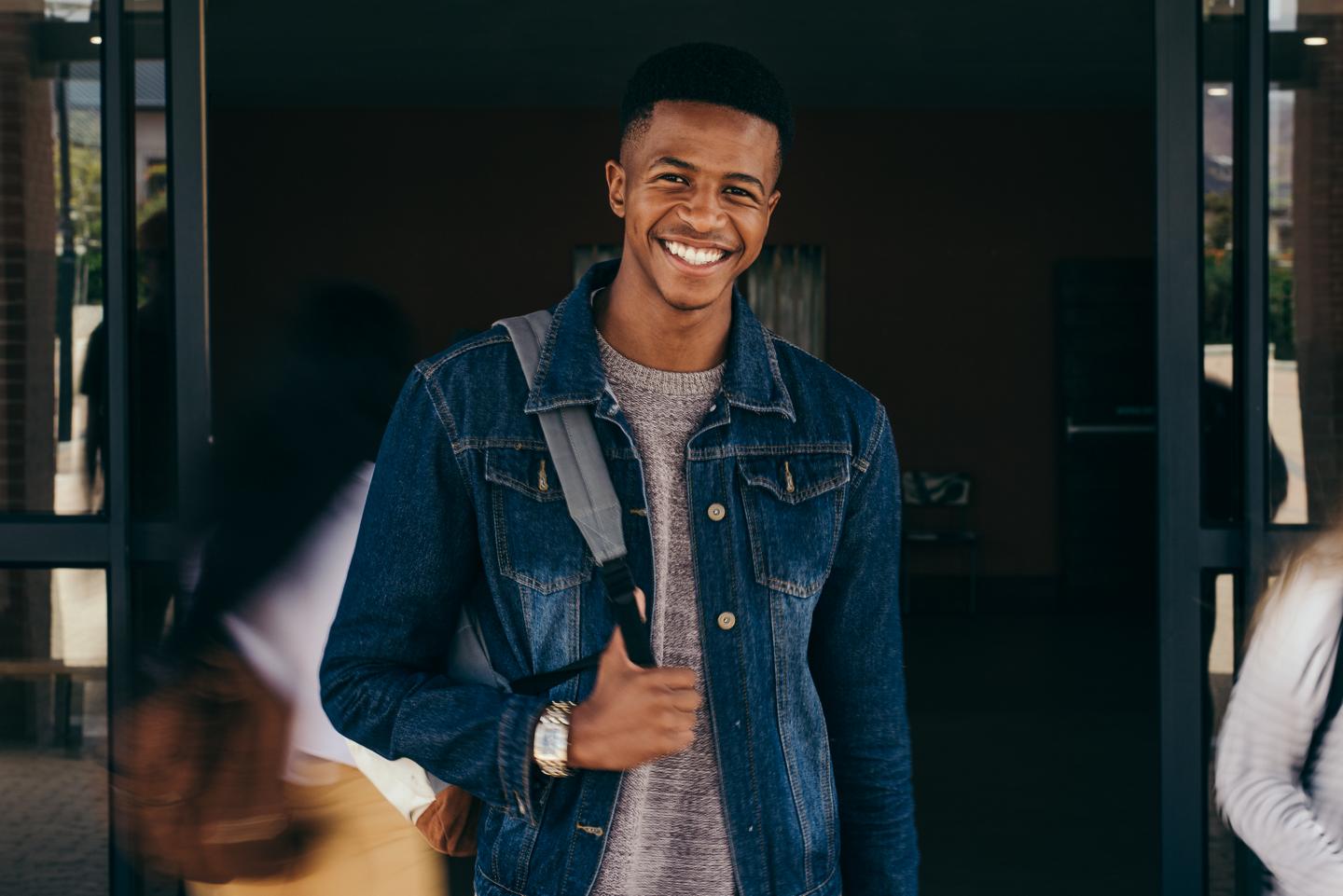 A young man wearing a backpack
