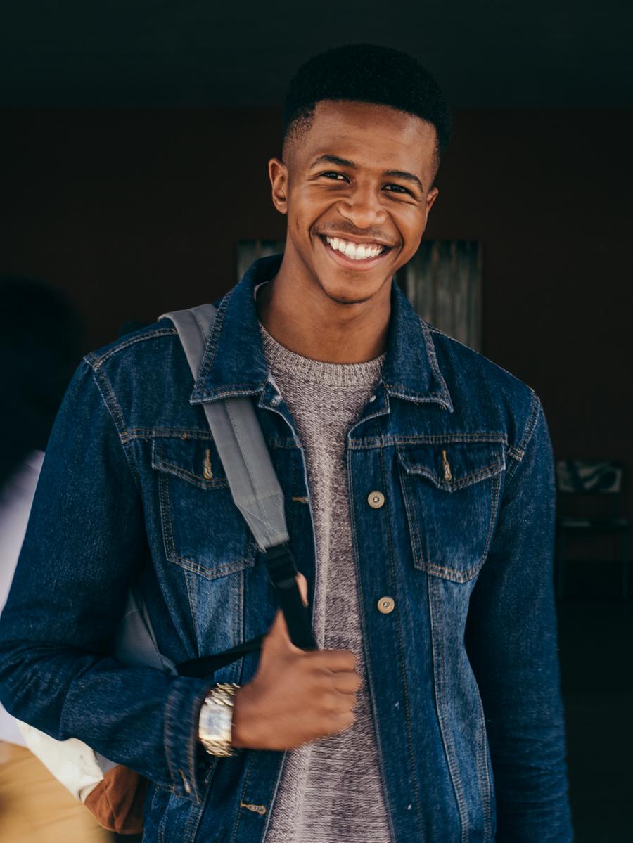 A young man wearing a backpack