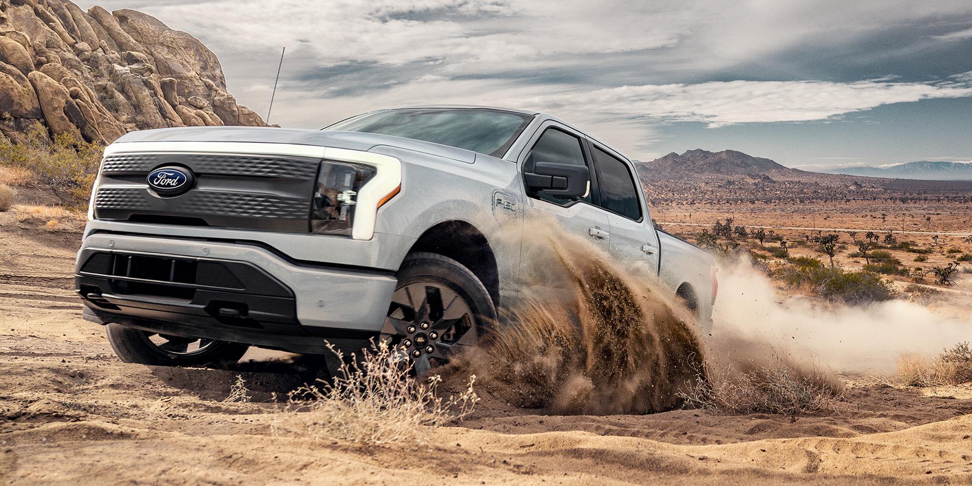 2025 Ford F-150® Lightning® driving in the desert sand