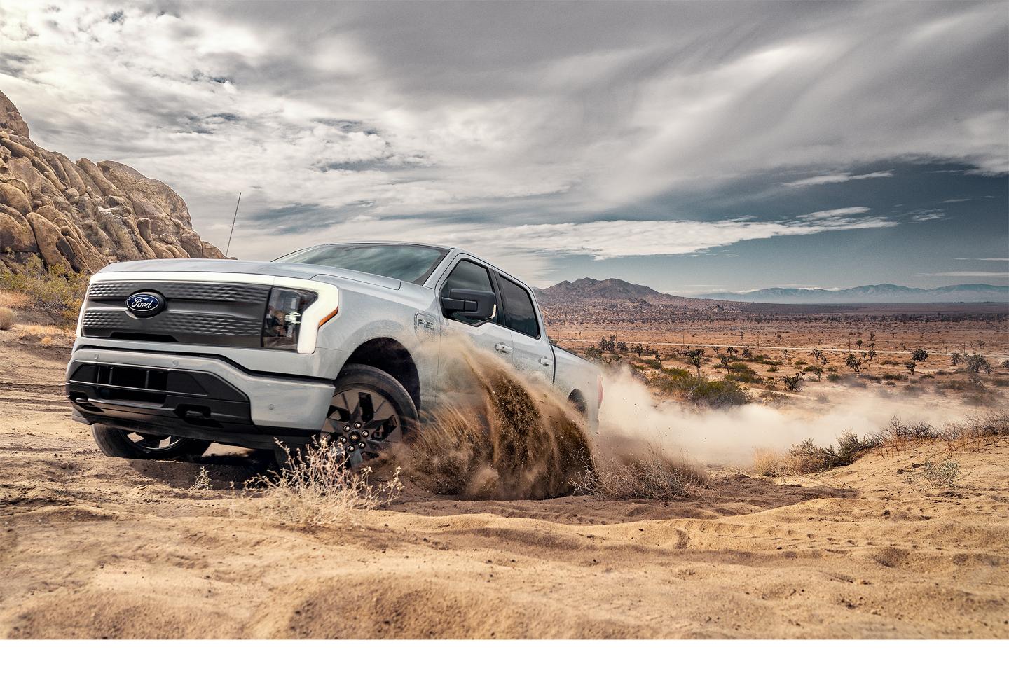 2025 Ford F-150® Lightning® driving in the desert sand