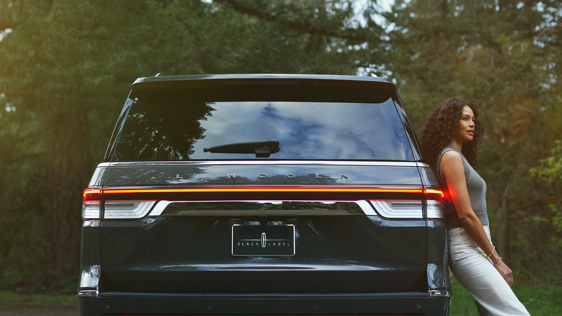 A woman leaning against the Lincoln Navigator