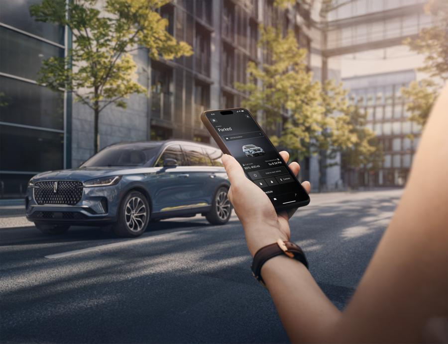 Woman using smart phone to access Lincoln app