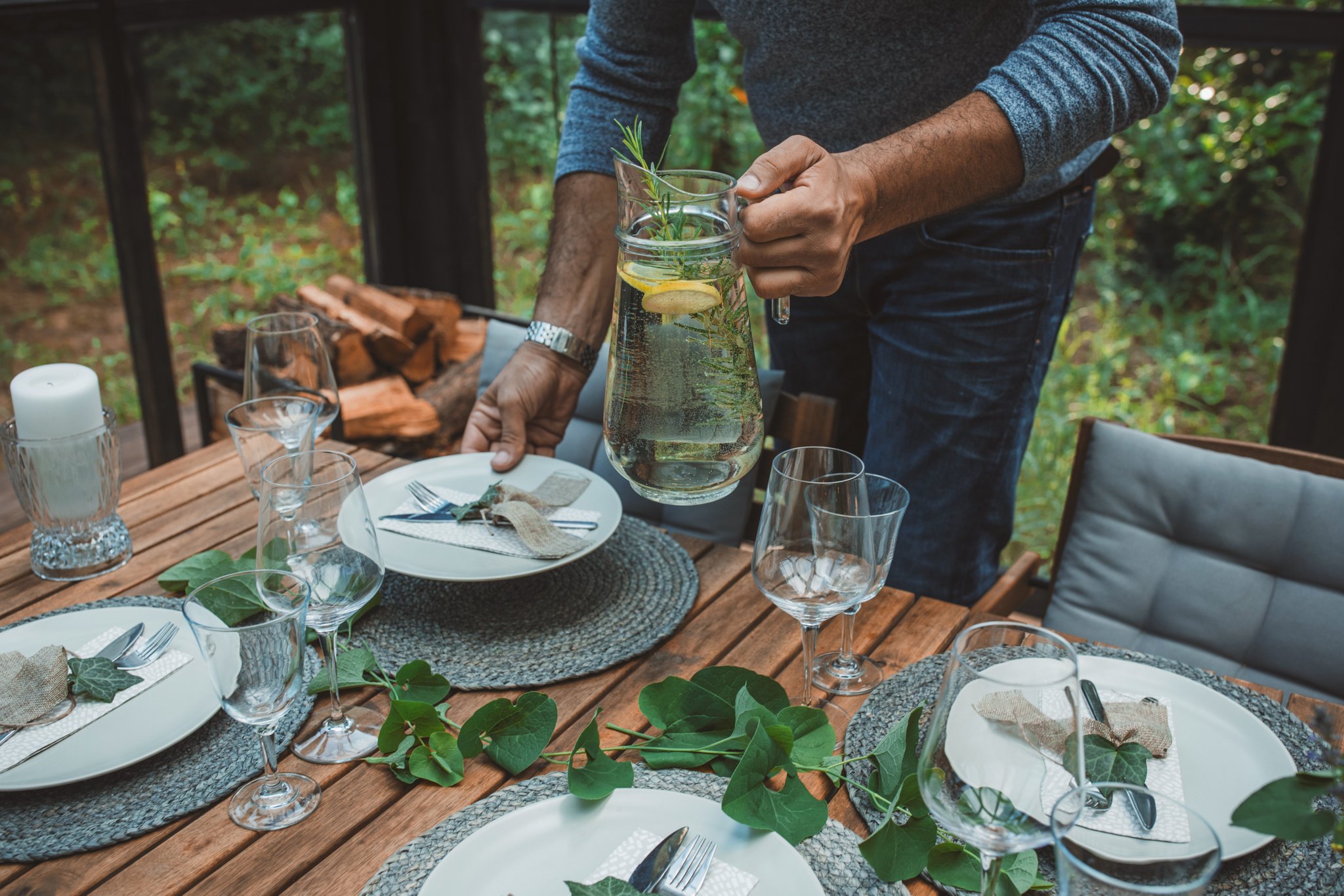 A person sets a dining table to reflect the spirit of the Lincoln Black Label™ Invitation theme