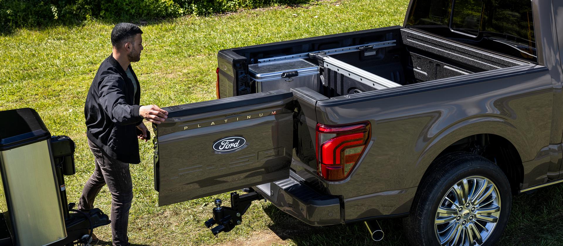 A man opening a truck bed