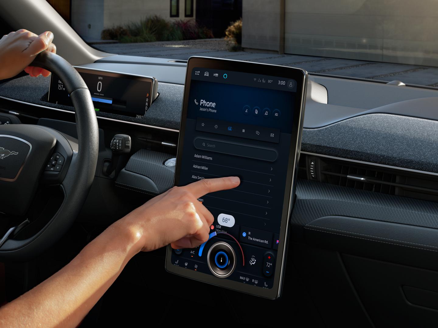 A woman's hand manipulating the SYNC touchscreen of a Ford Mustang Mach-E.