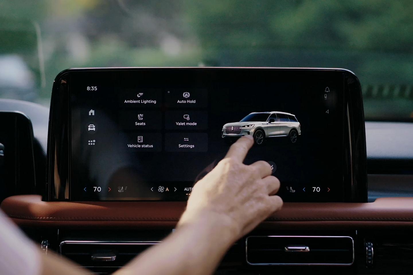 A person touches the center touchscreen to activate the power liftgate of a 2026 Lincoln Aviator® SUV