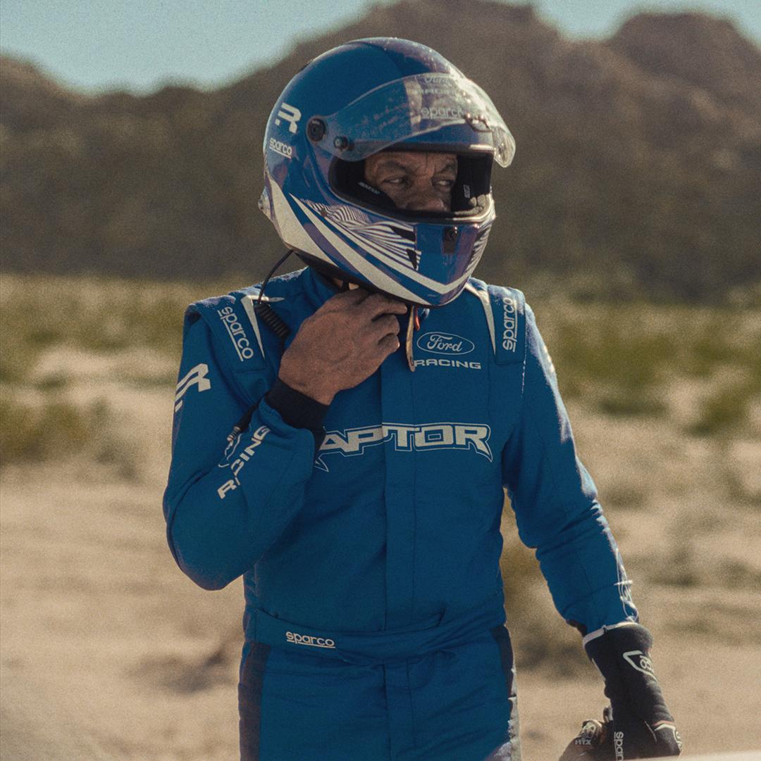 Person wearing a Raptor® race suit and helmet