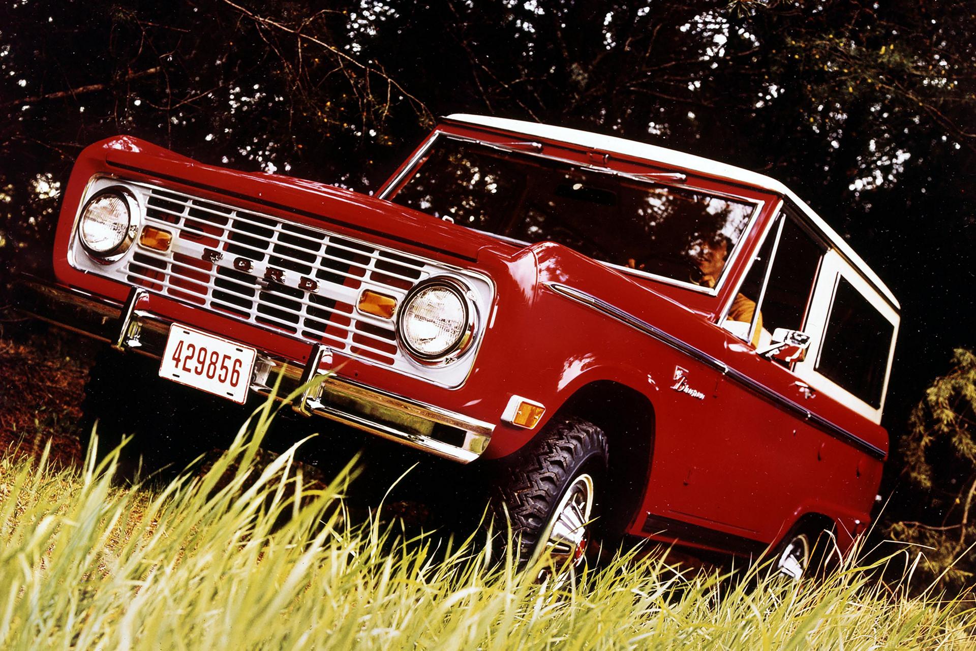 A 1969 Ford Bronco® Sport Package pictured being driven across a grassy plain