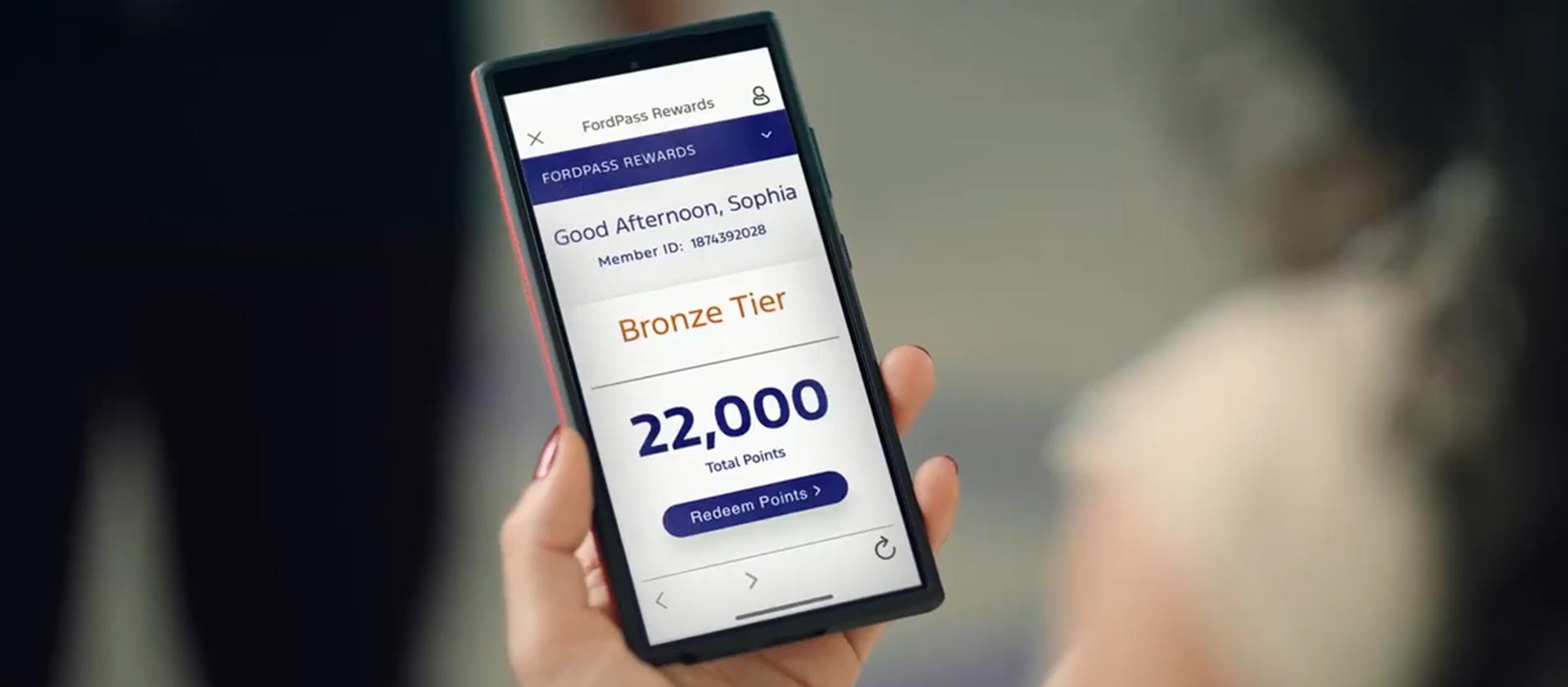 An owner checks their Reward Points on their phone