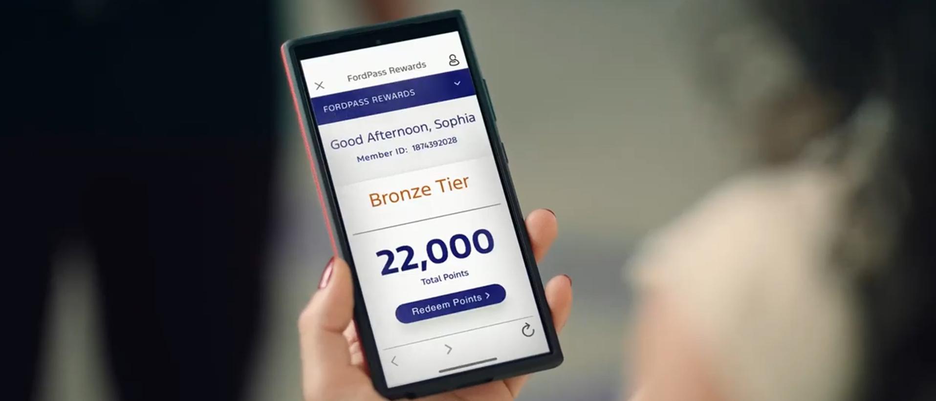 An owner checks their Reward Points on their phone
