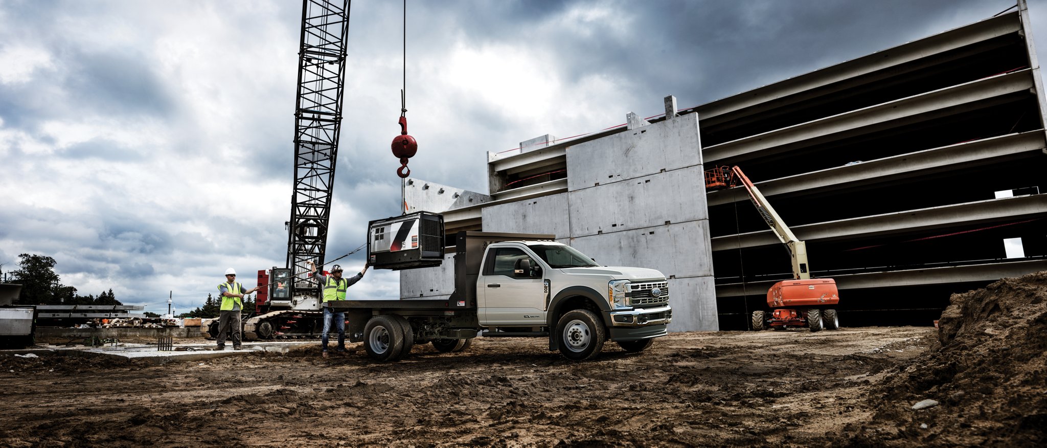 A 2025 Ford Super Duty® Chassis Cab on a construction site with equipment in the background