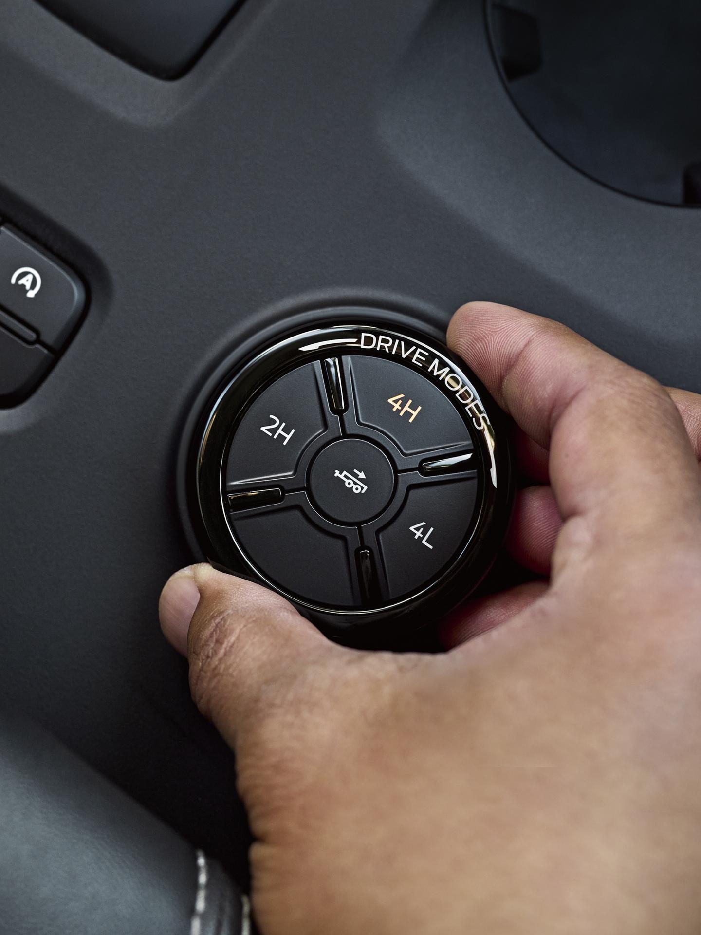 Close-up of a person's hand turning the drive mode dial on their 2026 Ford Ranger® truck