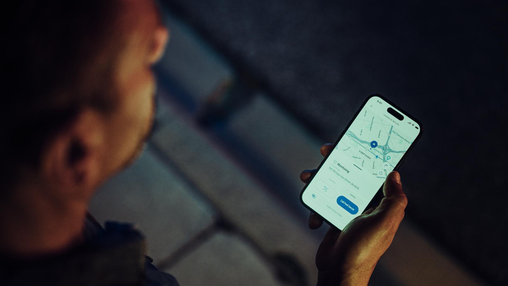 A person getting Ford Security Package alerts on a mobile phone