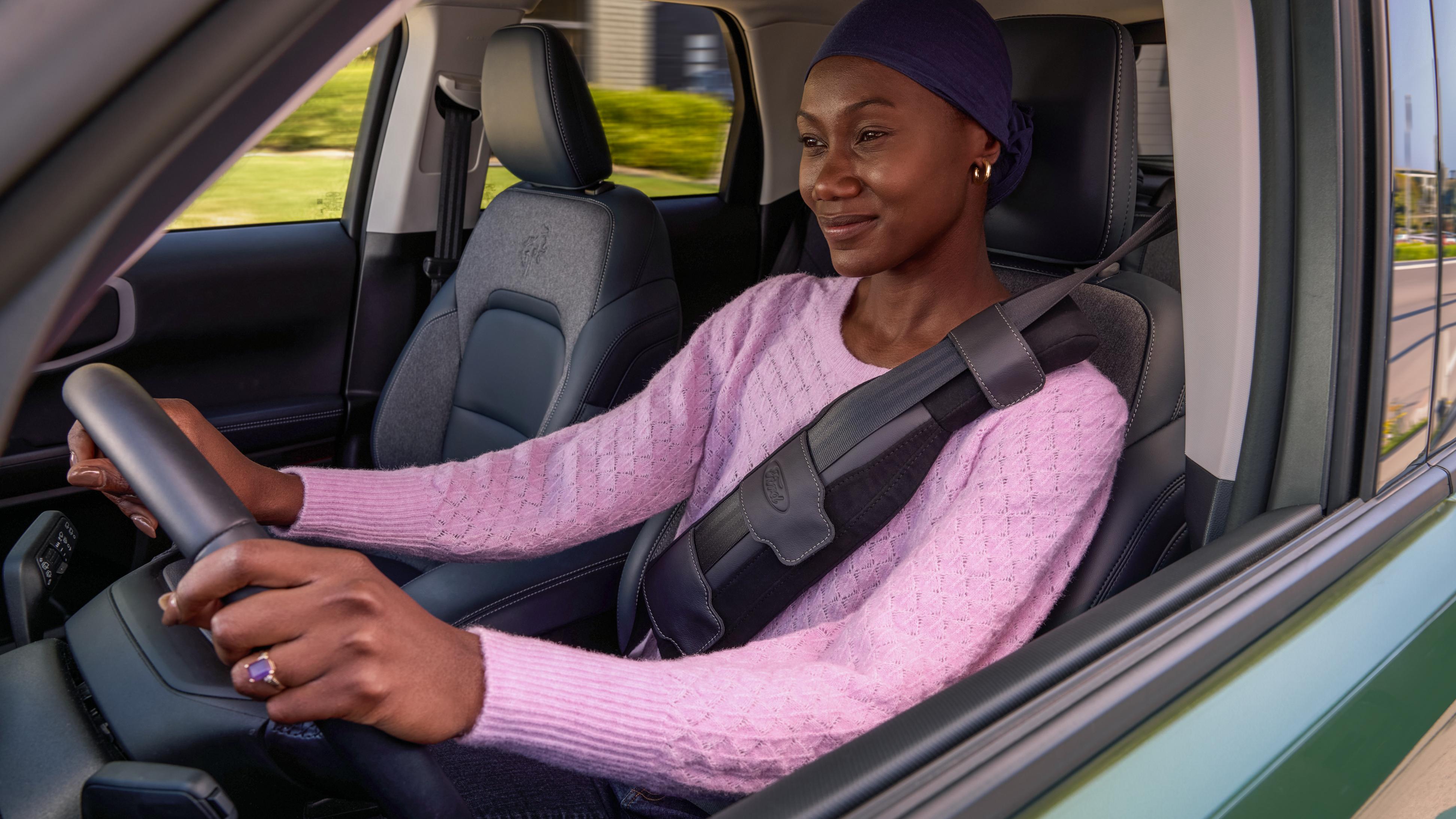 Woman driving a Ford vehicle using the Ford SupportBelt™