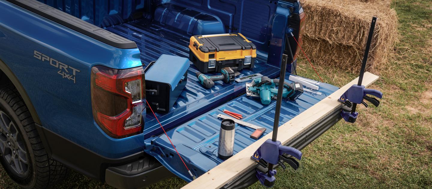 A 2026 Ford Ranger® truck with the tailgate open and a selection of tools inside the bed