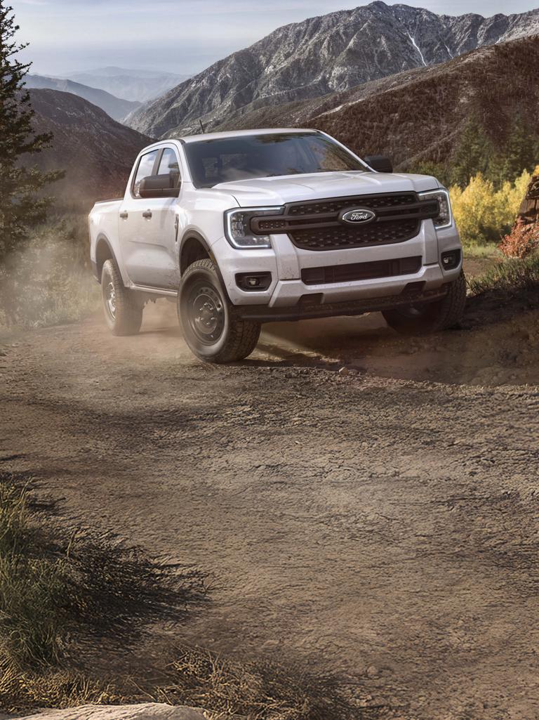 A 2026 Ford Ranger® XL model being driven off-road in the mountains