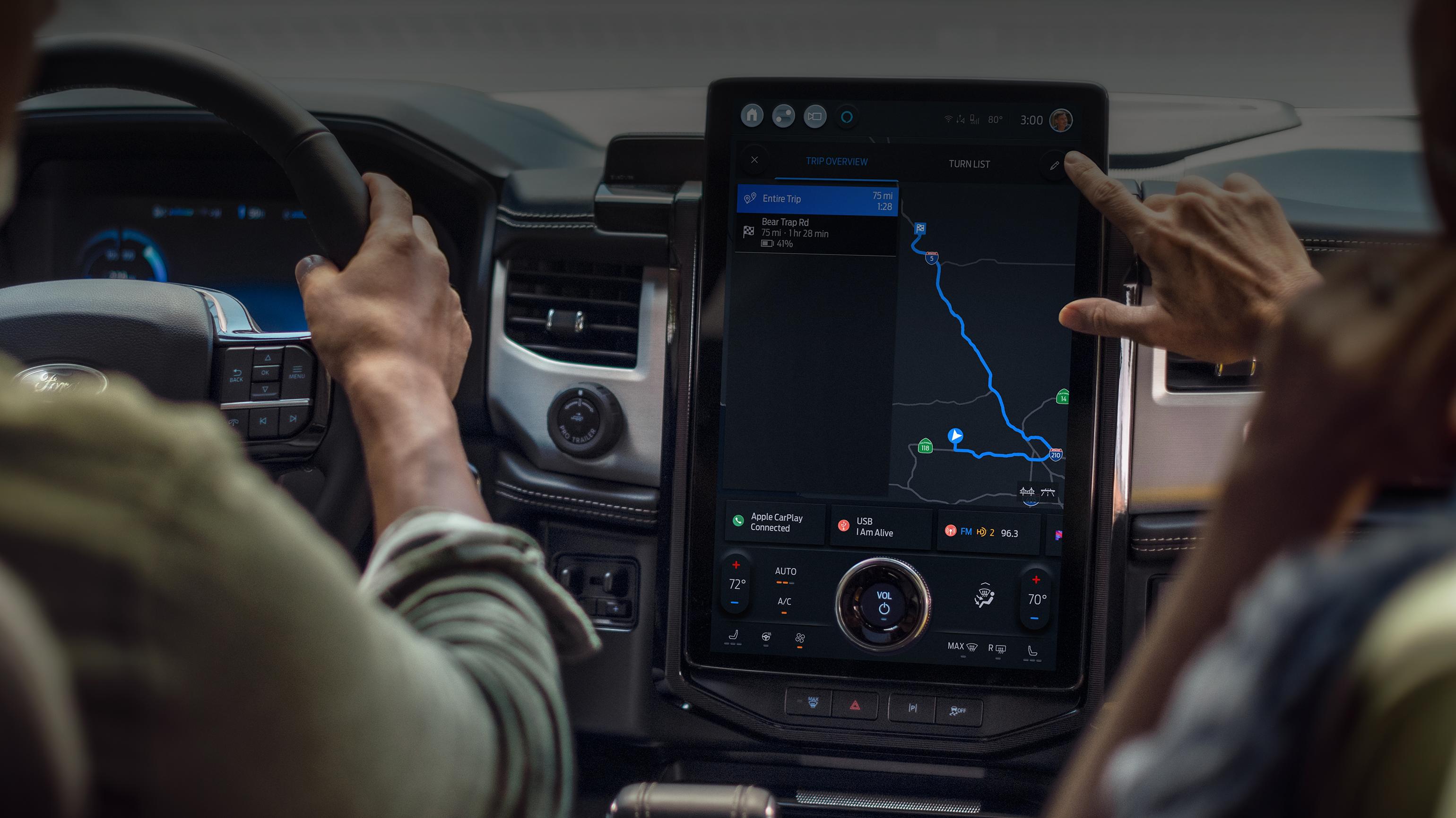 Driver using a Ford vehicle’s touchscreen navigation
