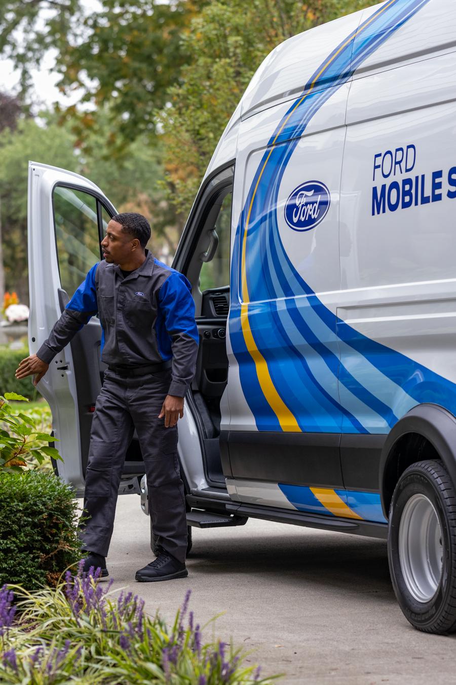 A Ford service tech exits their Ford Mobile Service van in a customer’s driveway