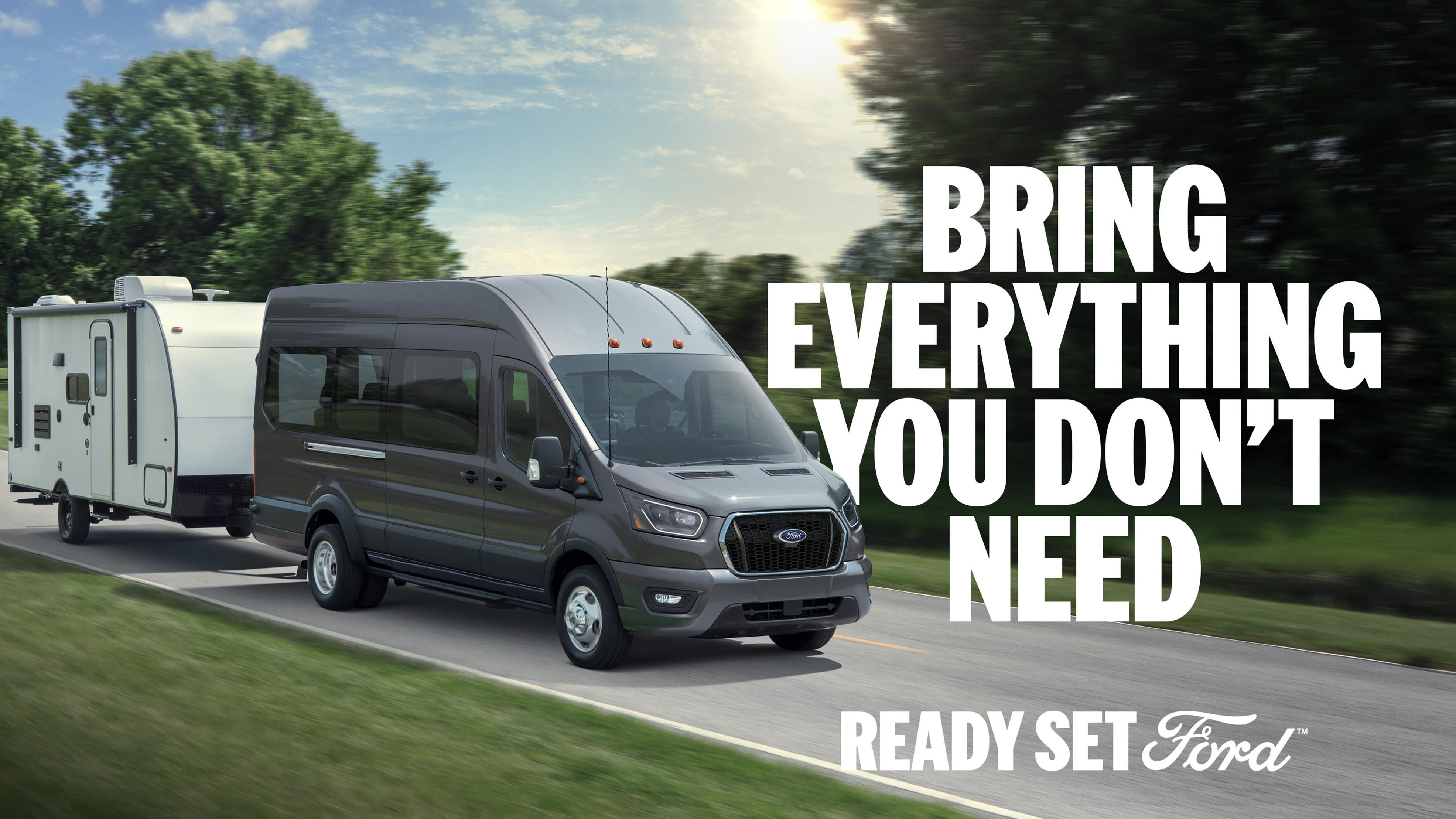 A 2026 Ford Transit® van towing a large item