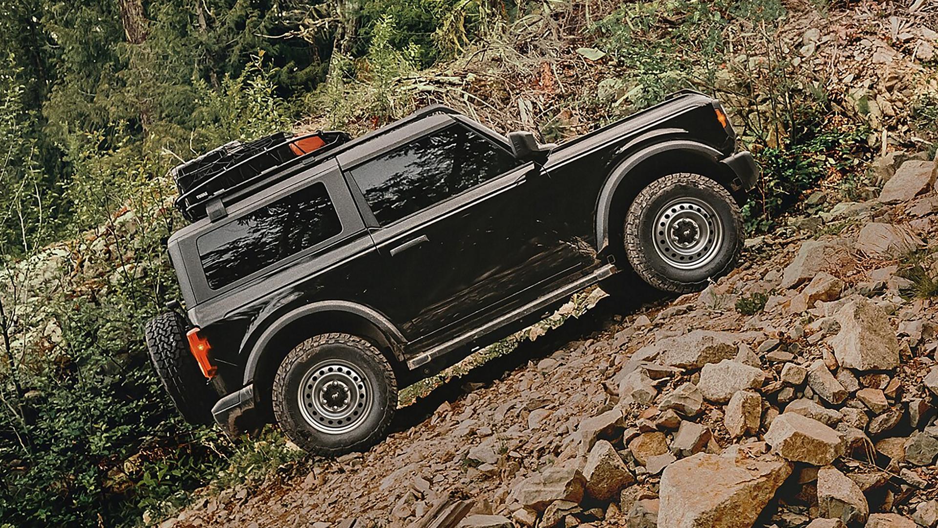 A 2026 Ford Bronco® SUV climbing a steep, rocky hill