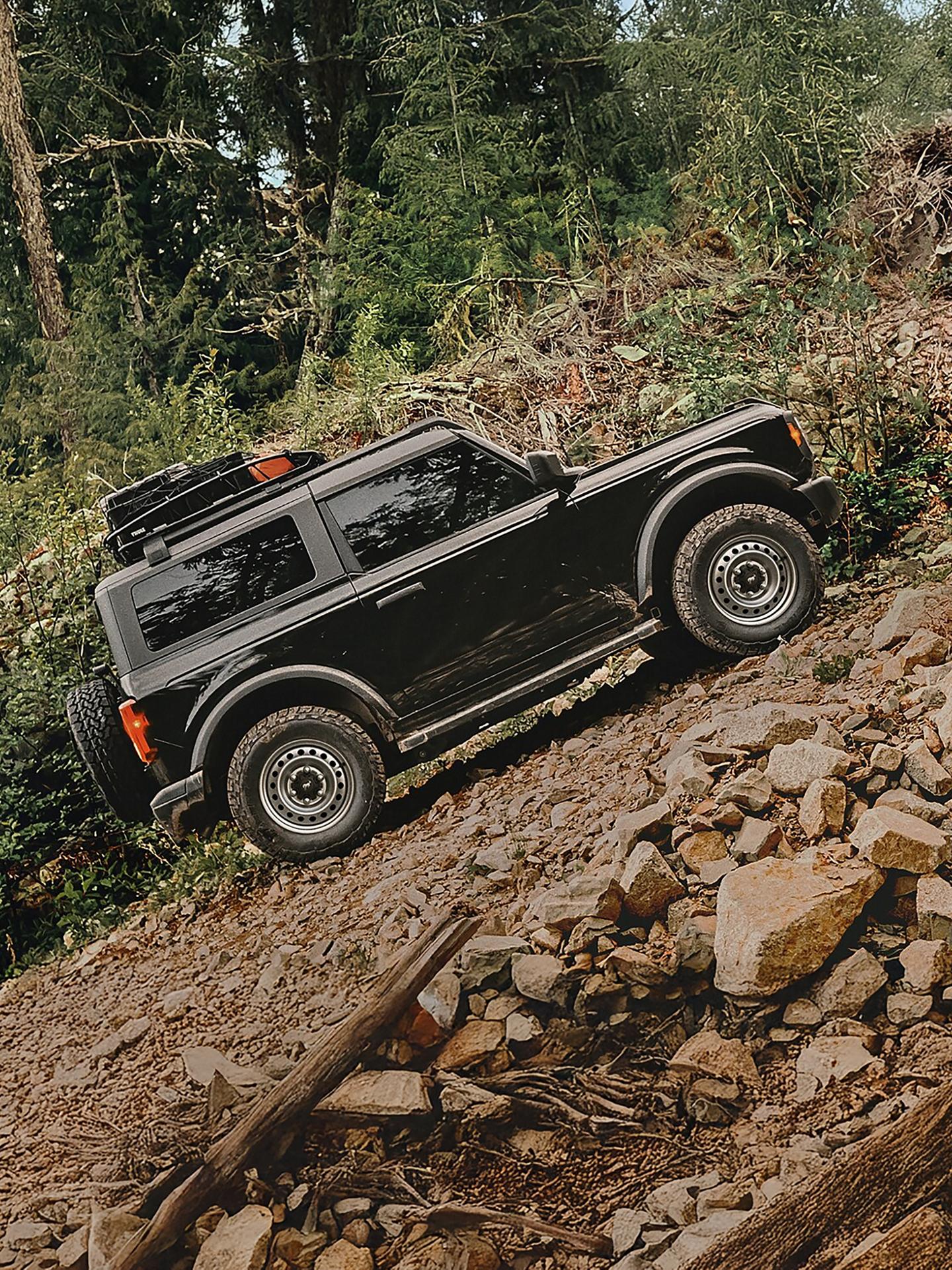 A 2026 Ford Bronco® SUV being driven up a rock pile