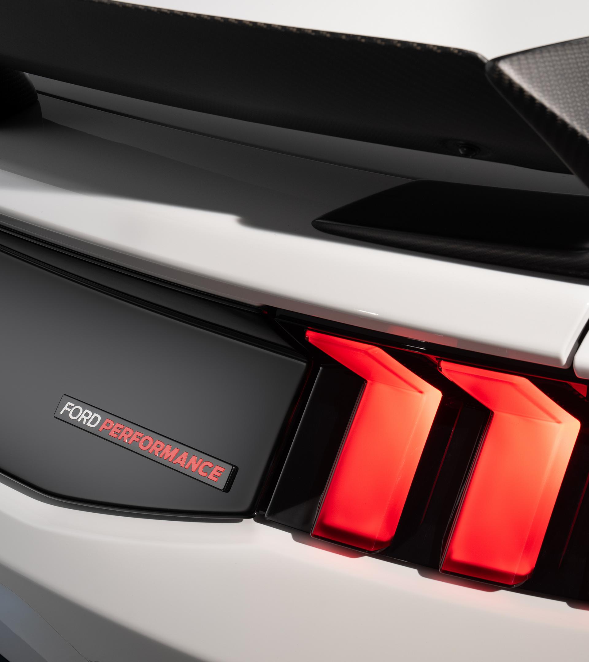 Rear detail of the gloss black trunk appliqué with taillights and Ford Performance badge
