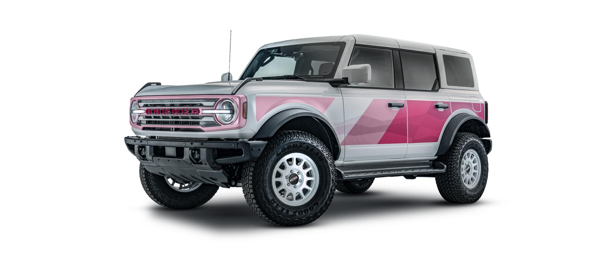 Front three-quarter view in the pink and white paint scheme