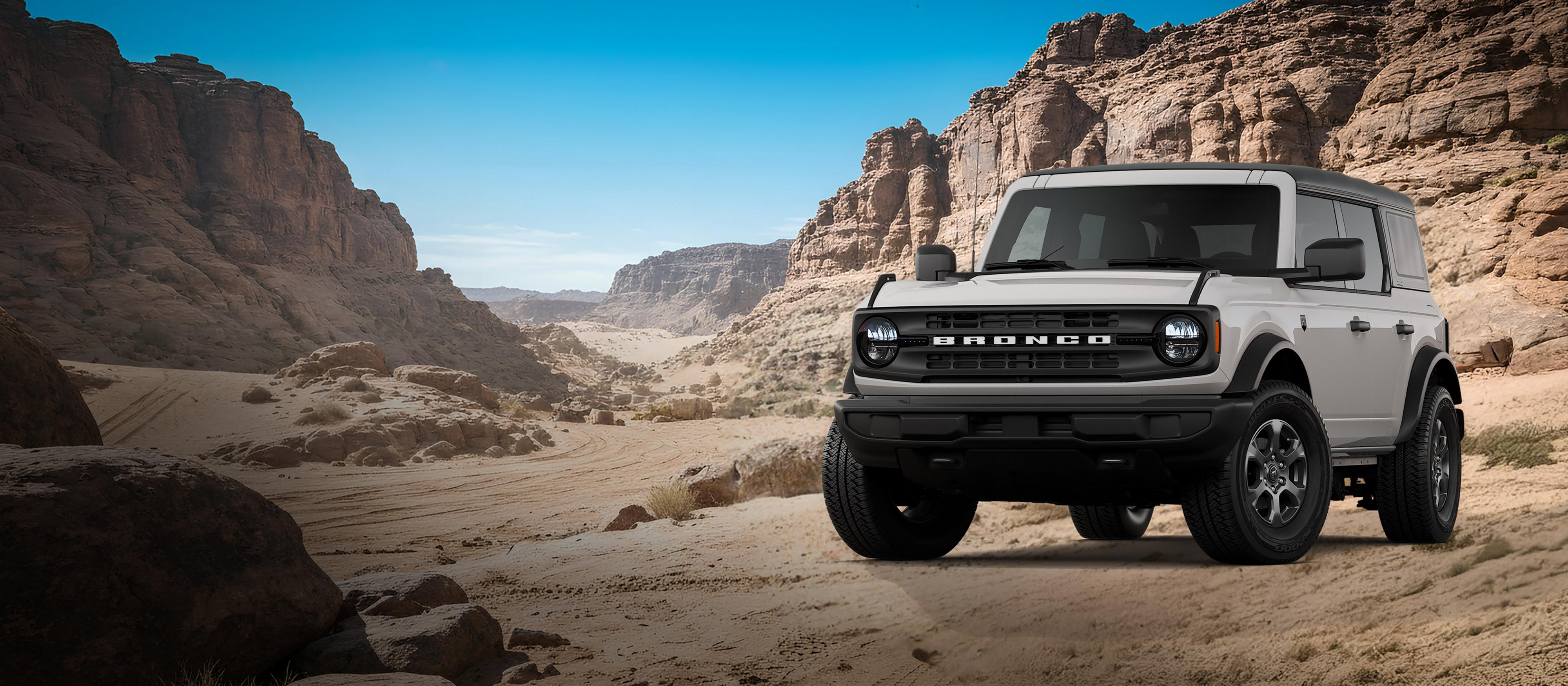 A 2026 Ford Bronco® Big Bend model shown in Avalanche Gray parked on a rocky expanse