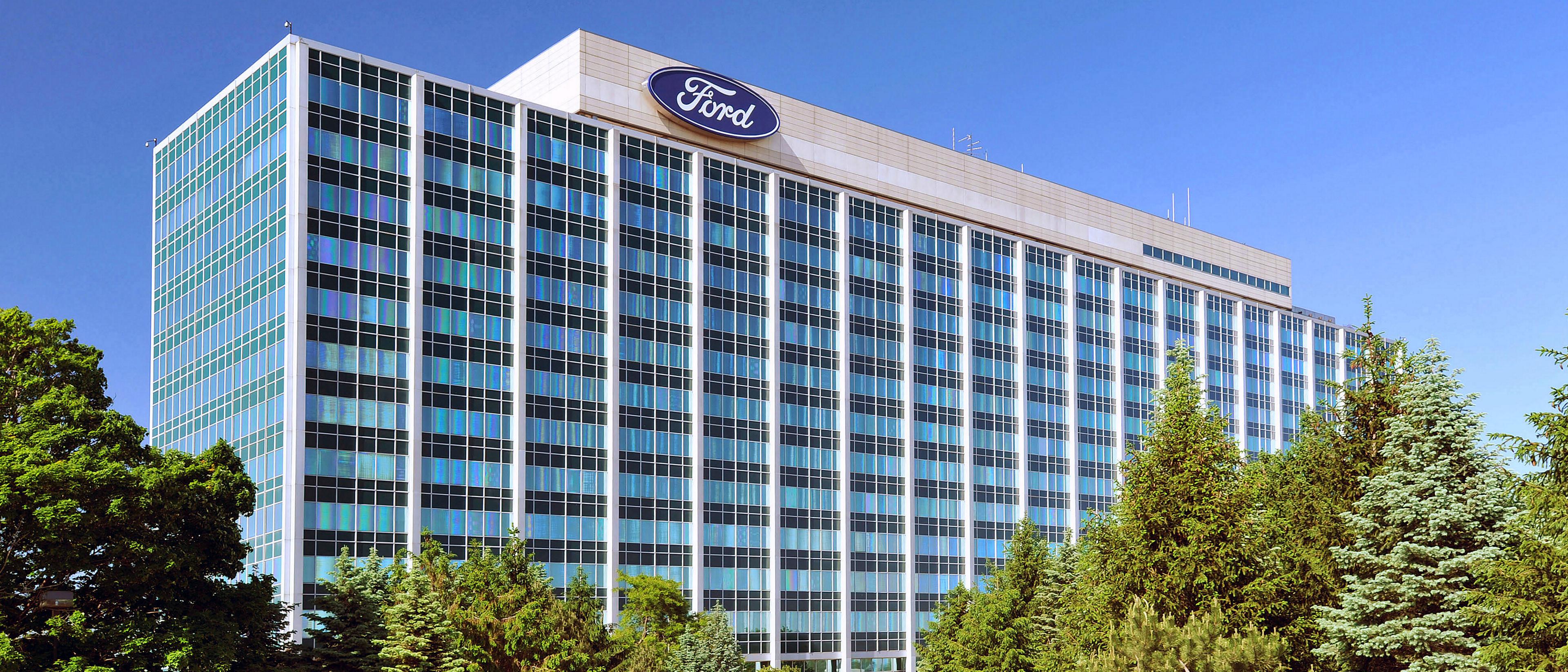 The Ford world headquarters building under a bright blue sky
