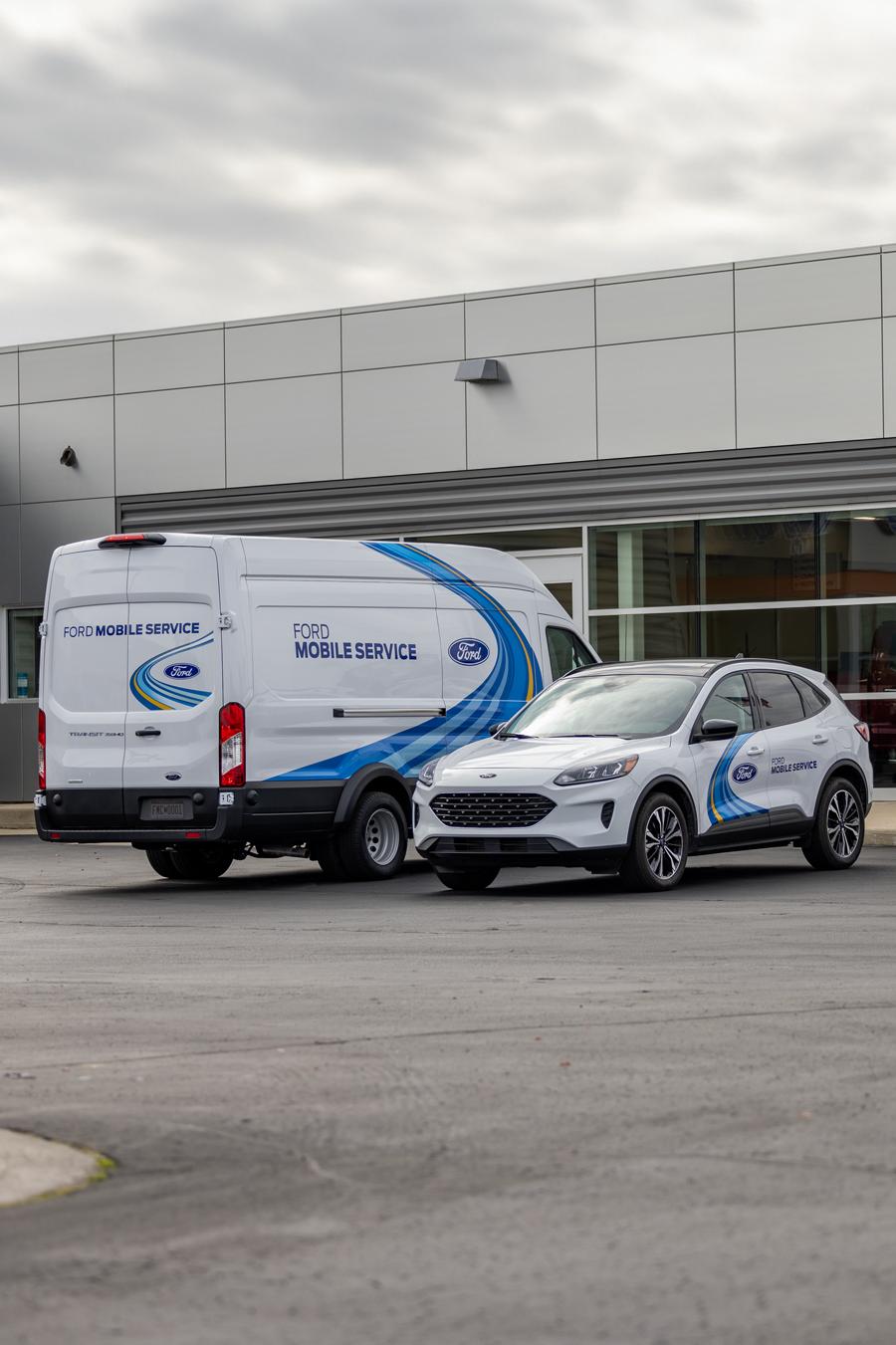 A Ford van and a Ford SUV parked in the parking lot of a Ford dealership