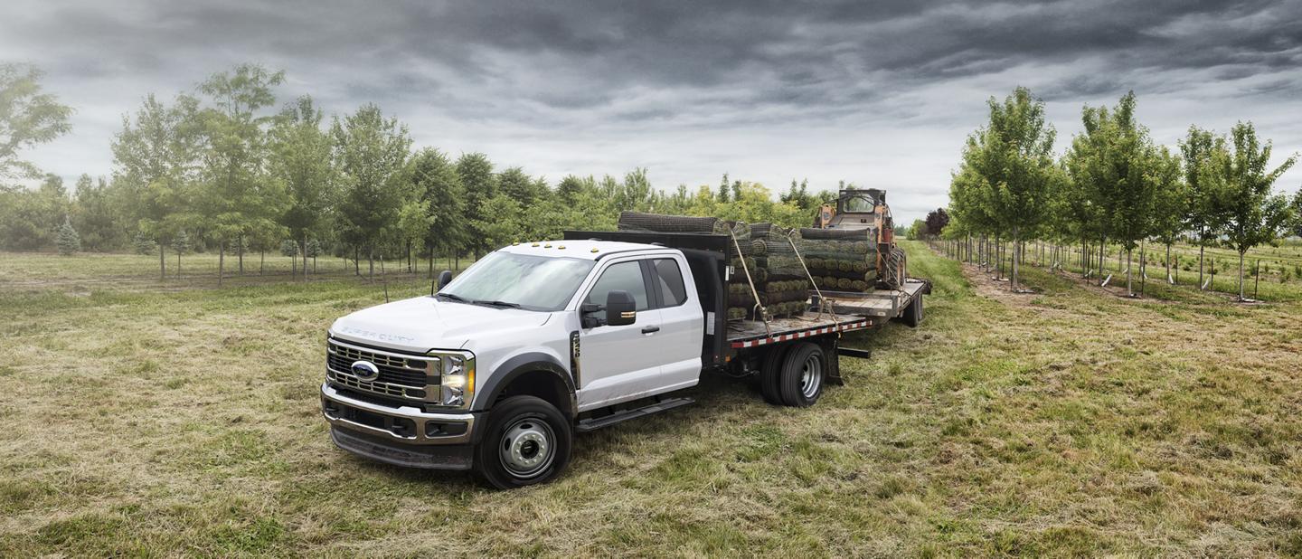2025 Ford Super Duty® F-350® loaded with sod and pulling a trailer with a Bobcat
