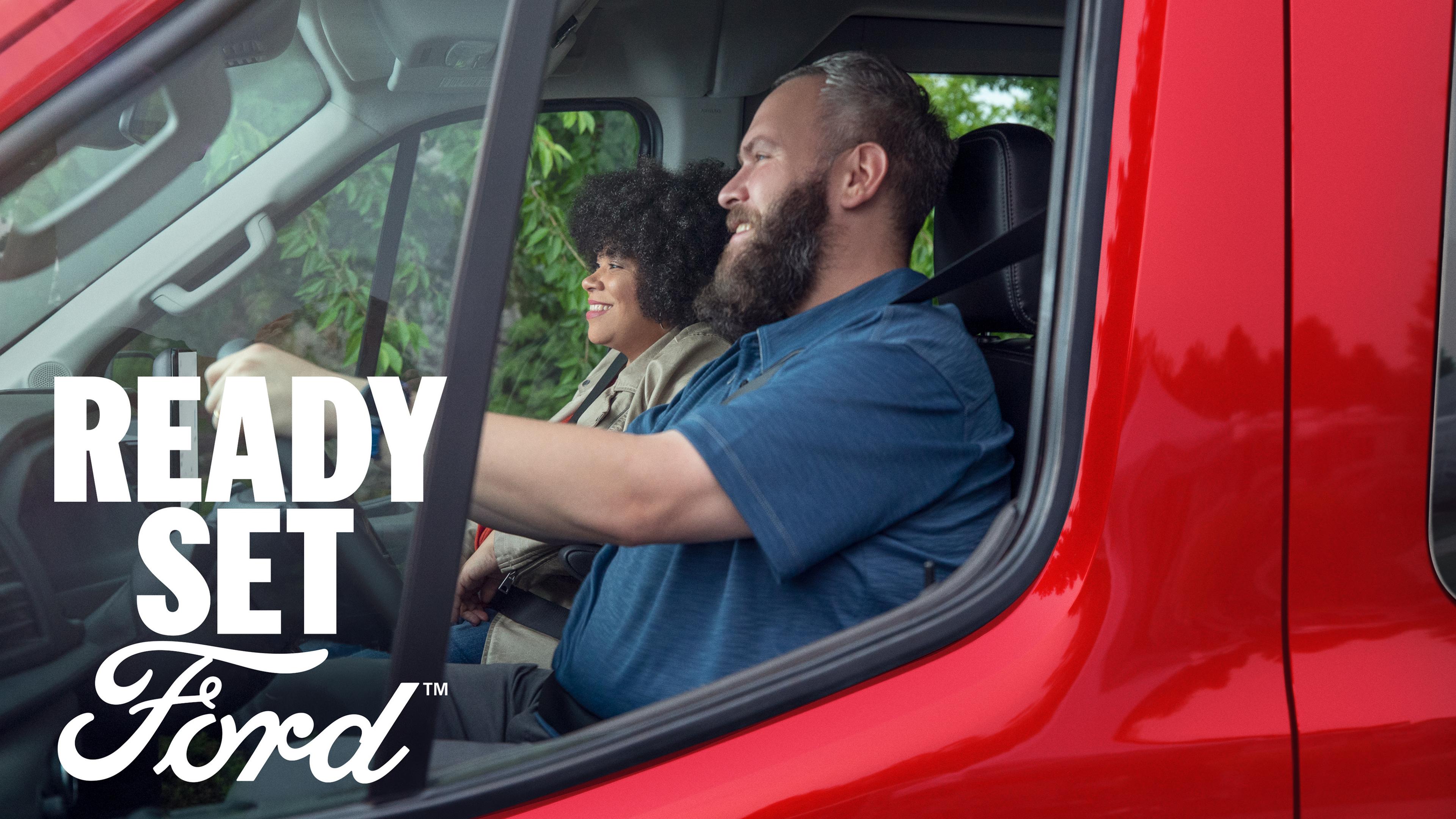 Close up of two people driving in a 2026 Ford Transit® van