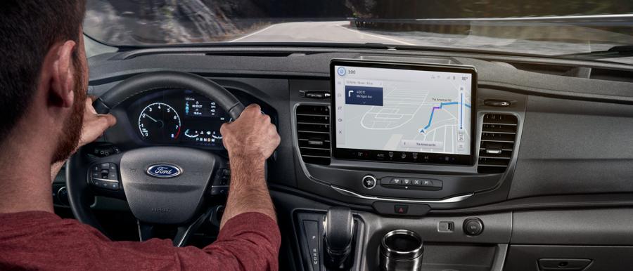 Person driving a 2025 Ford Transit® model with available SYNC® 4 and 12-inch multi-function display
