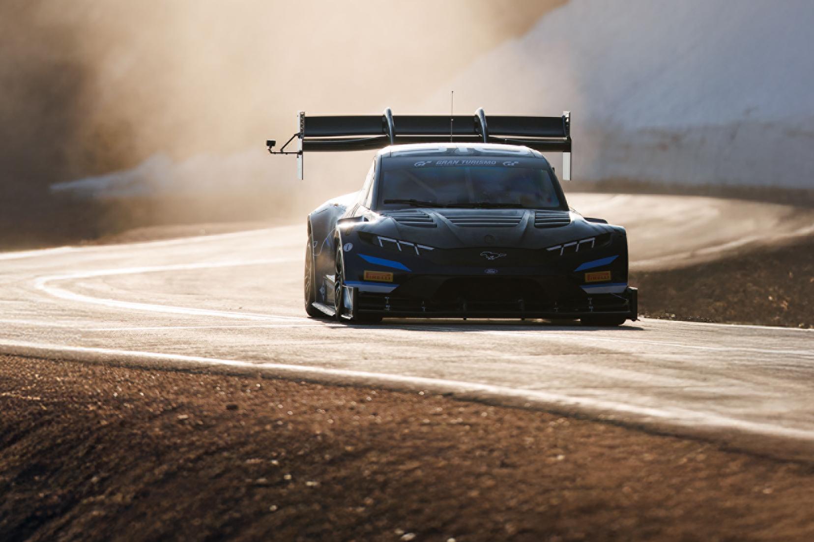 2025 Ford Super Mustang Mach-E racing on track through mountains in Pikes Peak