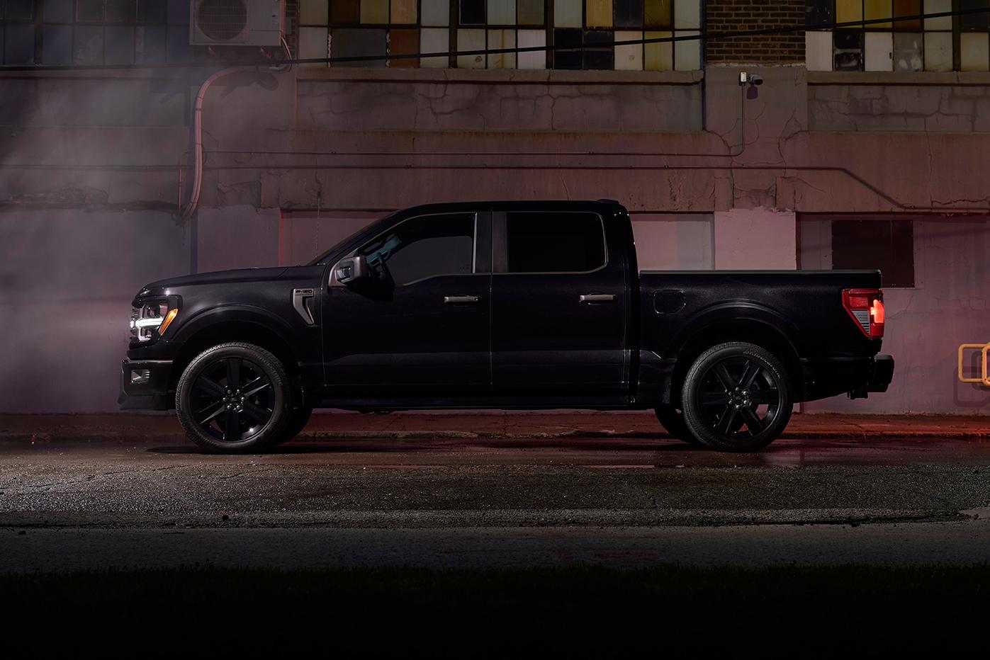 An Ford F-150® parked on the street with the lights on