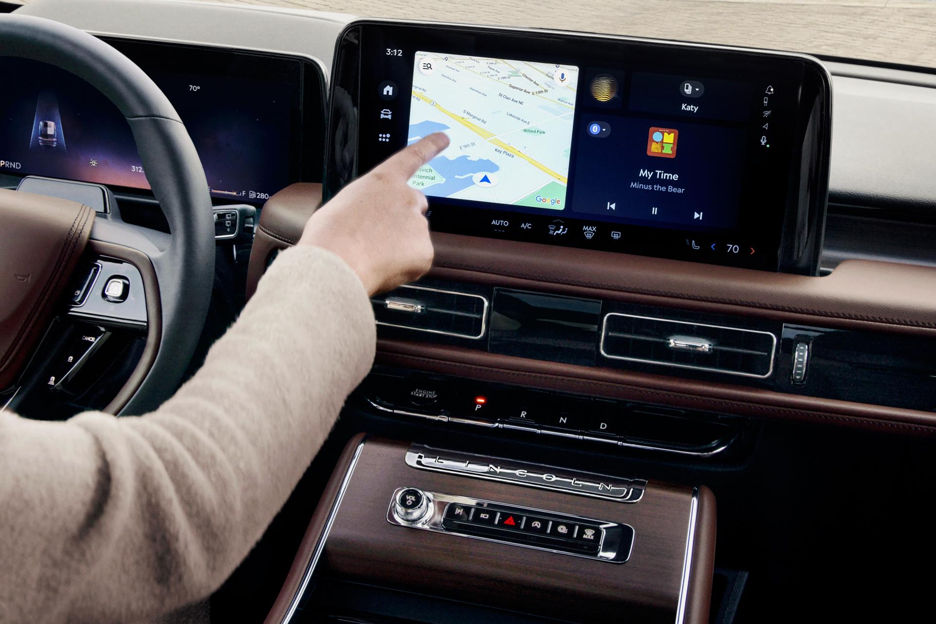 The driver of a 2025 Lincoln Aviator® SUV touches the center touchscreen