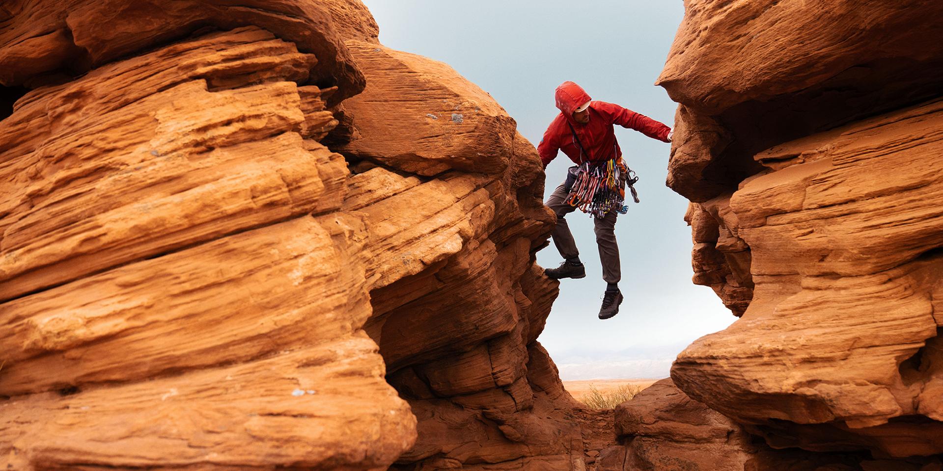 A rock climber picks a path in the gap between two crags