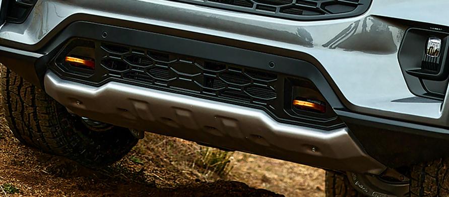 A 2026 Ford Explorer® SUV driving up a grassy hill