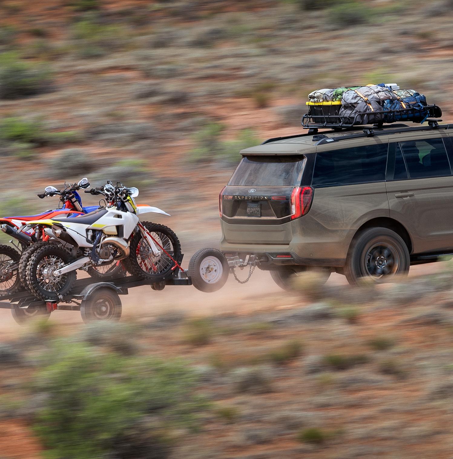 2026 Ford Expedition® Tremor® SUV towing a dirt bike trailer in the desert