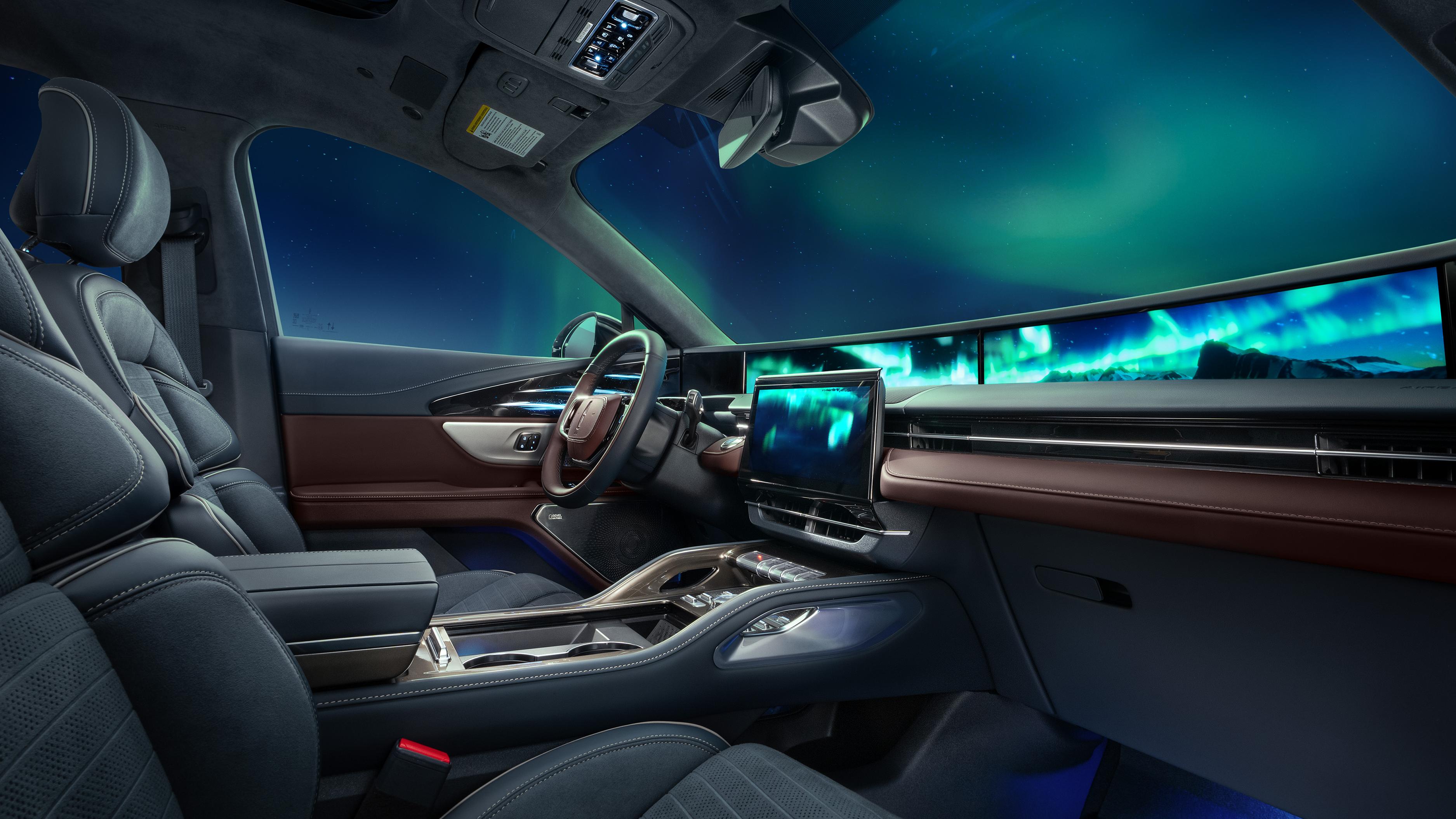 The northern lights seen through the windshield of a 2026 Lincoln Black Label™ Nautilus® SUV with the Aurora interior theme