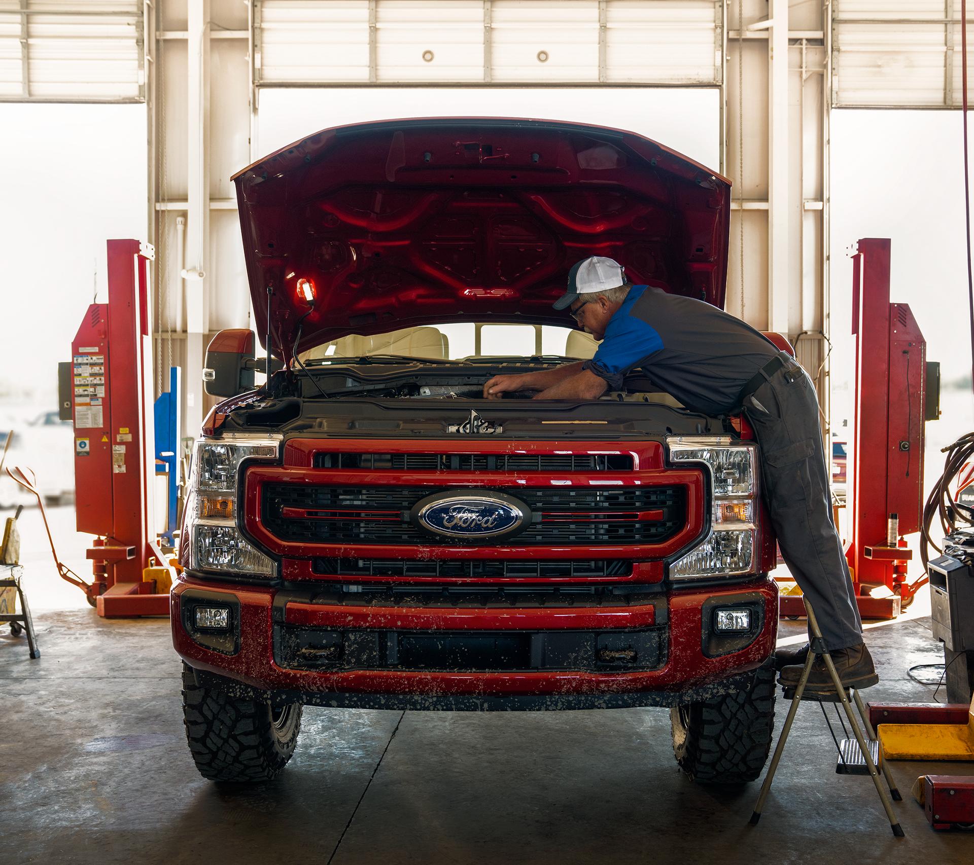 A Ford technician works on a Ford Super Duty® truck
