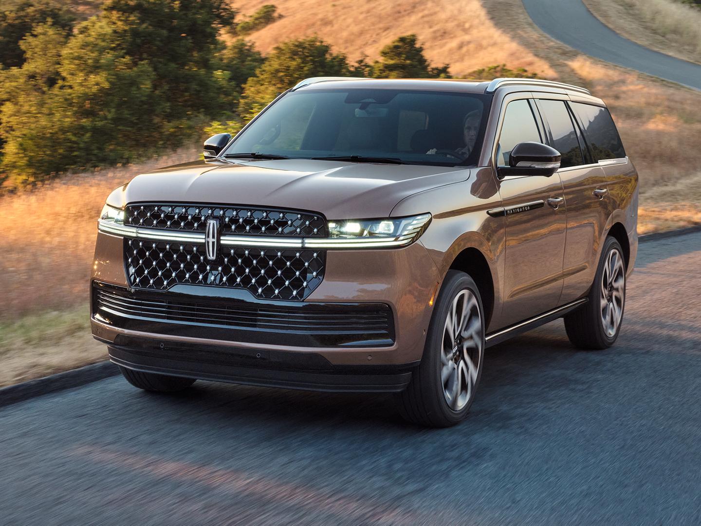 The 2025 Lincoln Navigator driving down the road.